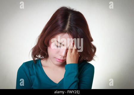 Headache. Young asian woman having a headache Stock Photo