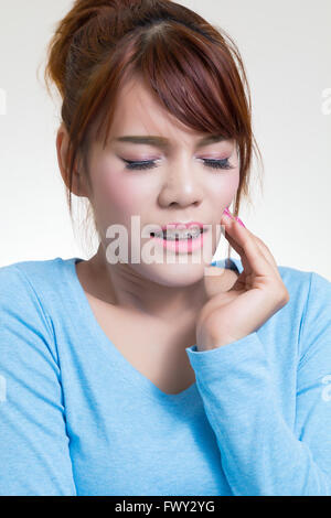 Beautiful young asian woman suffering from toothache Stock Photo