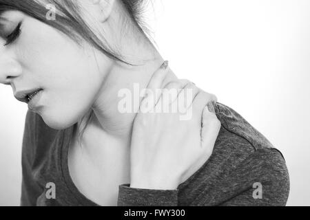 Young woman holding  neck in pain and discomfort Stock Photo