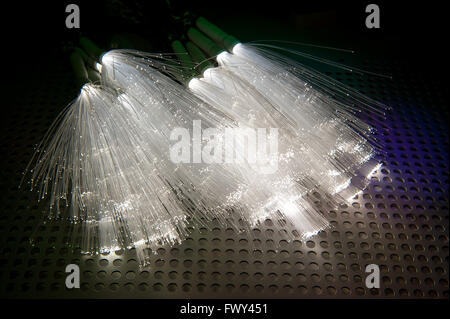 optical fibres dinamic flying from deep on technology background Stock Photo