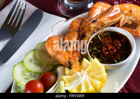 An English pub/bar dish of Sautéed King Prawns with Sweet Chili and Tamarind dip and a fresh side salad. Stock Photo