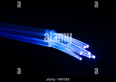 optical fibres dinamic flying from deep on technology background Stock Photo