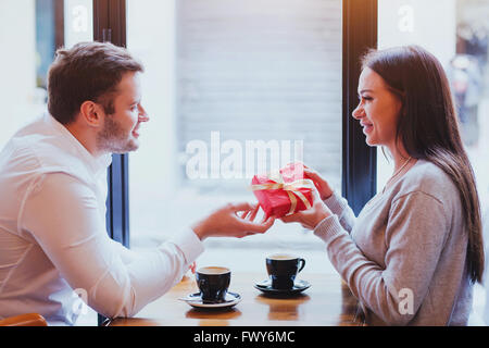 gift for valentines day, birthday or anniversary, man and woman in cafe, couple portrait Stock Photo