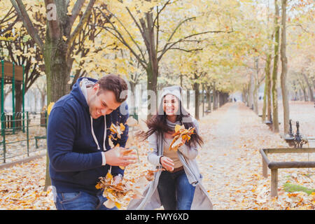 happy young couple playing and laughing together in autumn park Stock Photo