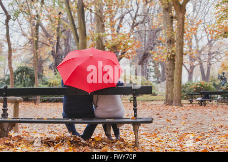 couple under umbrella in autumn park, love concept, happy elderly people Stock Photo