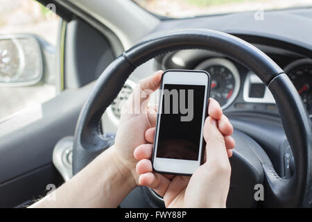 smartphone in the car, male hands holding mobile with empty screen Stock Photo