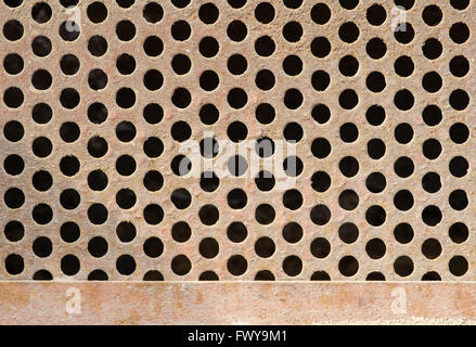 Texture of old rusty dirty grate with circle holes. Stock Photo