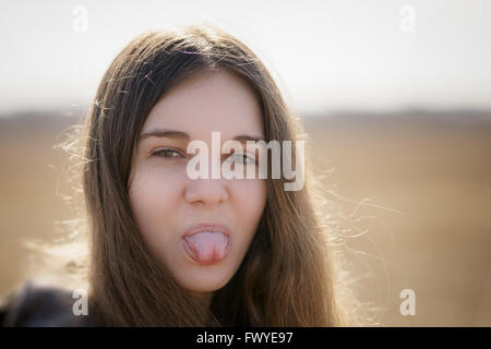 close up portrait of young girl showing tongue Stock Photo