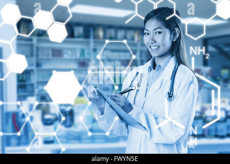 Composite image of asian doctor writing on files Stock Photo