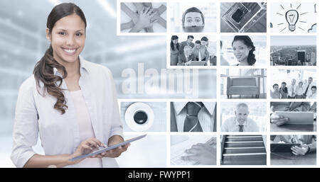 Composite image of woman using tablet pc Stock Photo