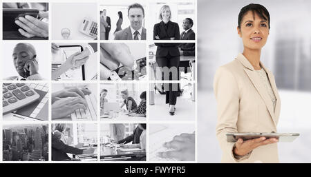 Composite image of businesswoman holding tablet pc Stock Photo