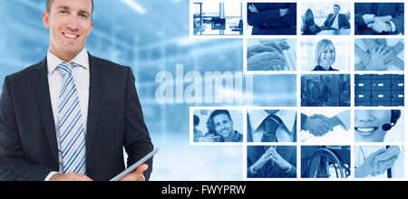 Composite image of businessman using tablet pc Stock Photo