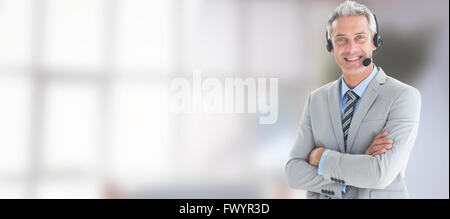 Composite image of businessman with executives using computers Stock Photo