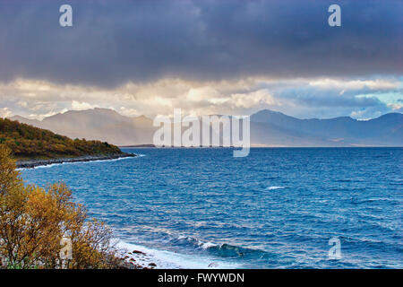 Rain shower over island Andøya in northern Norway seen from Nupen near Harstad on island Hinnøya. Stock Photo