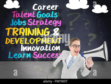 Geeky businessman shouting through megaphone Stock Photo