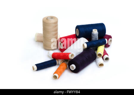 Heap of plenty colorful thread reels isolated on white background. Stock Photo