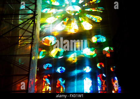 Coloured light streaming through stained glass window, Sagrada Familia, Barcelona, Spain Stock Photo