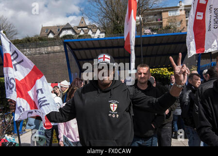 High Wycombe, Buckinghamshire, UK. 9th April 2016. An EDL supporter makes the peace sign. An English Defence League demonstration has passed without major incident, the group marched from the High Wycombe train station and was escorted by a large number of Police to the town centre. There was also a large counter-protest. Three people were arrested on suspicion of public order offences and one person was arrested on suspicion of criminal damage. Credit:  Peter Manning/Alamy Live News Stock Photo