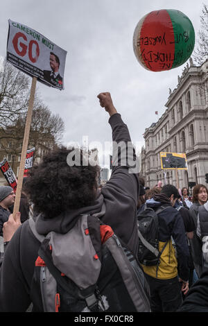 Whitehall, UK. 9th April, 2016. A protester punches a ball with an anti-austerity message into the air at the 'David Cameron Must Go' rally, on Whitehall, Saturday 9th April 2016. Credit:  Andy Davidson/Alamy Live News Stock Photo