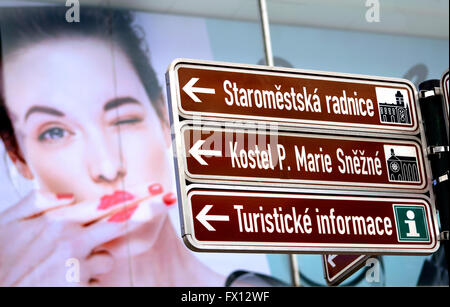 Prague, Czech Republic. Signpost to tourist attractions (Old Town Hall; St Mary Convent; Tourist Info) in front of shop... Stock Photo