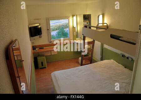 A standard budget hotel room (in the IBIS Budget Reims Thillois 2 star hotel) in Reims, France. Stock Photo