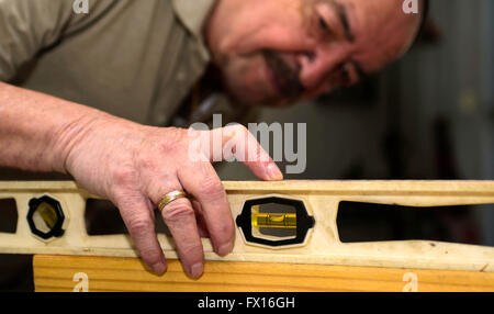 Carpenter using a level Stock Photo