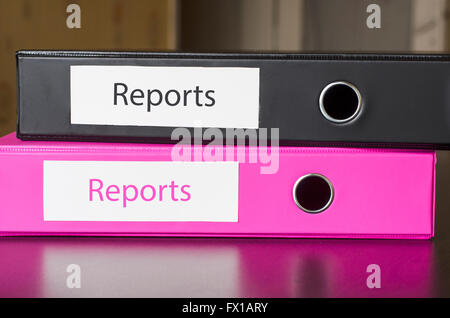 Bright office folders over dark background and reports text concept Stock Photo