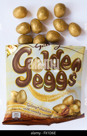 Bag of new Galaxy golden eggs Galaxy chocolate with crunchy caramel rolled in gold with contents spilled isolated on white background ready for Easter Stock Photo