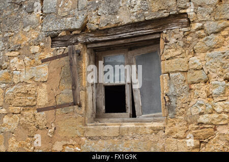 Window in old french house in need of repair, near Sarlat in the Dordogne region of France Stock Photo