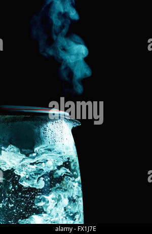 glass electric kettle with boiling water, black background Stock Photo