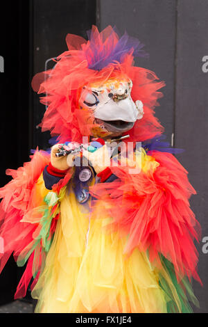 Close view on a single Basel carnival participant playing piccolo and wearing a bird like costume. Stock Photo