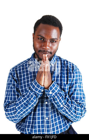 A young black man standing isolated for white background, folding his hands  and praying. Stock Photo