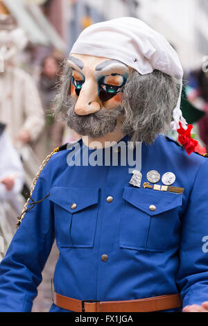One single participant of the Basel carnival 2016 wearing a blue costume and representing an elderly man with mustache. Stock Photo