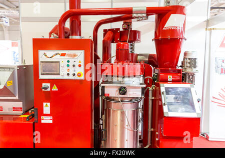 Red recycling machine. Recycles plastic and glass bottles. Control panel with computer monitor and different buttons. Stock Photo