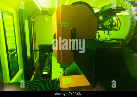 High precision CNC laser cutting elements out of a metal sheet. Isolated laser cutting machine. Stock Photo