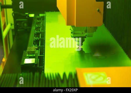 High precision CNC laser cutting elements out of a metal sheet. Isolated laser cutting machine. Stock Photo