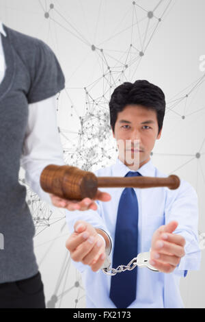 Composite image of woman holding a gavel and scales of justice Stock Photo