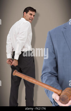 Composite image of male lawyer holding scale and gavel against white background Stock Photo