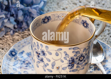 Pouring Tea into China Teacup Stock Photo