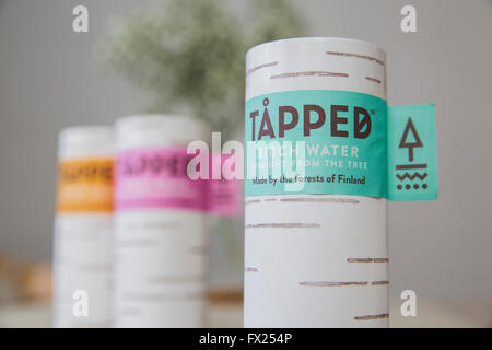 Tapped Birch water cartons on a wooden kitchen table in natural light. Stock Photo