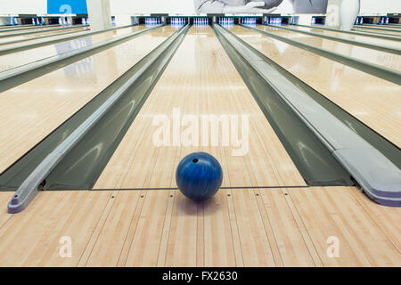 Balls on bowling alley against ten pins Stock Photo