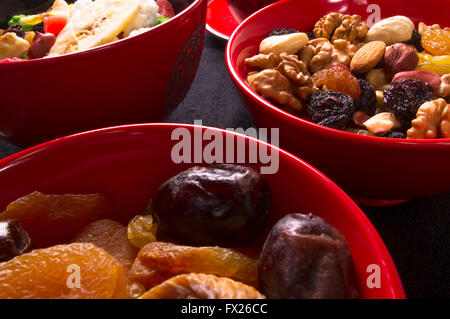 various mix nuts, dried fruits and fresh fruits on the black background Stock Photo