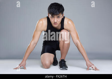 Male athlete preparing to run Stock Photo