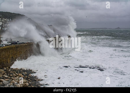 Mousehole, Cornwall, UK. 10th April 2016. UK Weather.  Big waves continue to hit Mousehole harbour at the high spring tide with a startling contrast to yesterdays calm and sunny afternoon. Credit:  Simon Maycock/Alamy Live News Stock Photo
