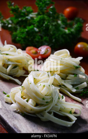 fettuccine aglio e olio with garnish cerry tomato and  parsley Stock Photo