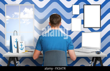 Guy work in blue white office. Laptop and picture frames isolated for mockup. Creative scene with sailor sign on bags, watch and Stock Photo