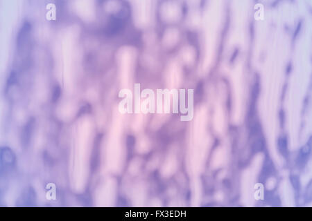 Blurred picture of a foam on windshield made in a car wash, abstract background. Stock Photo