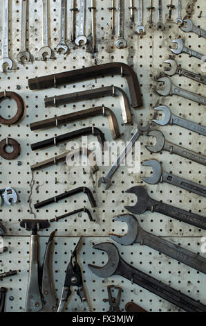 A row of hose reels hanging from the ceiling of an automotive repair shop  Stock Photo - Alamy