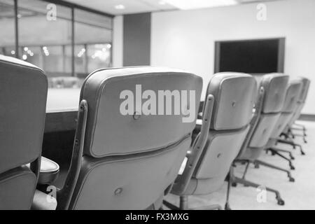 Empty seats at a board room table. Stock Photo