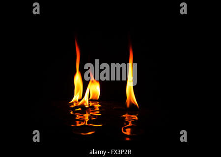 Four indyvidual flames of fire isolated black with reflection on bottom,interesting photo.Horizontal view. Stock Photo